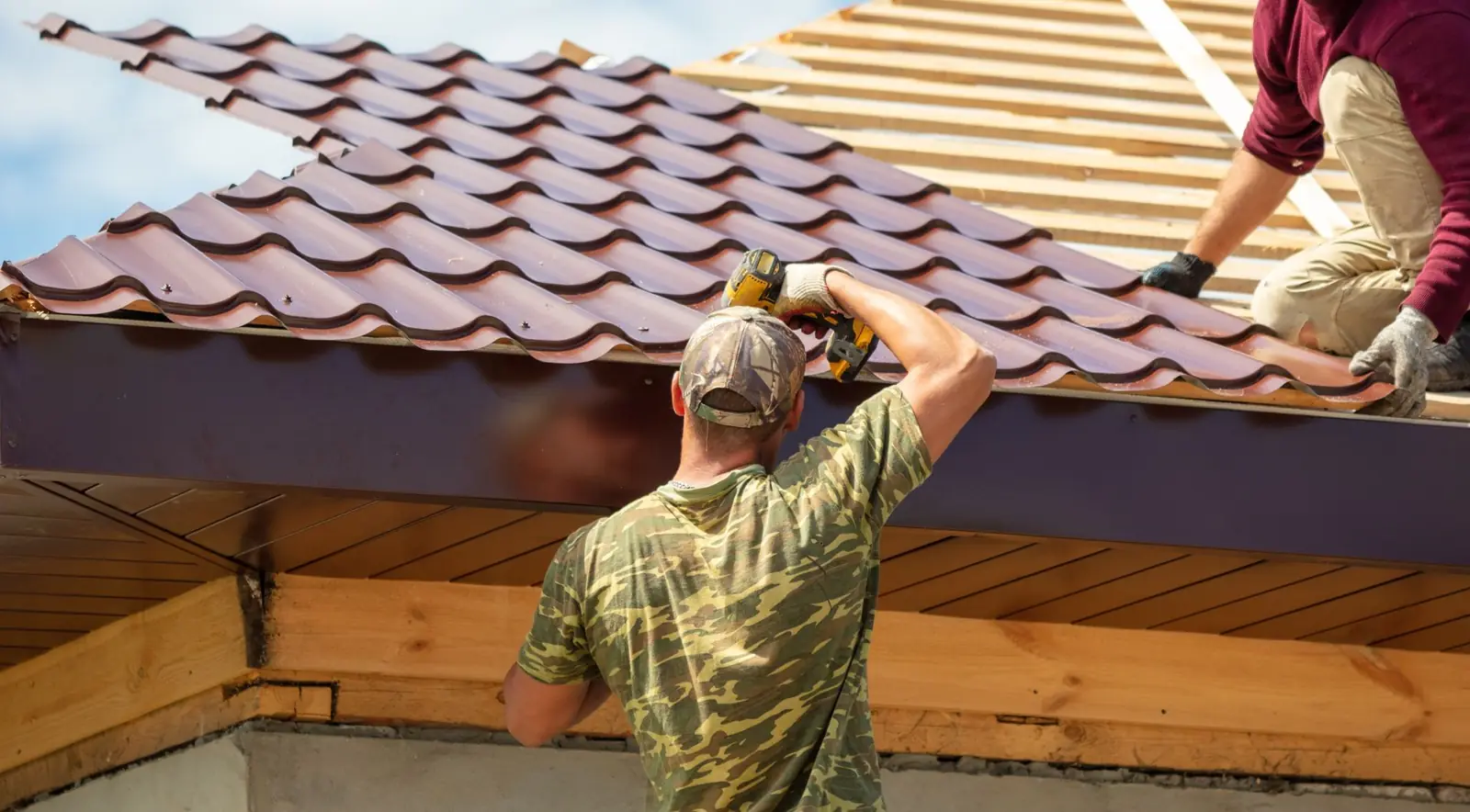 Roofer installing tiles on a new roof